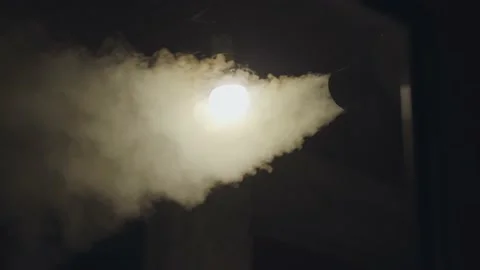 Gray smoke generator, located next to a lamp in a dark room. Energy concept Stock Footage 197737583