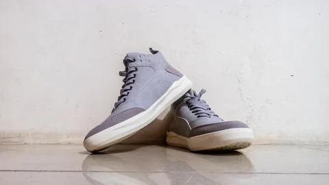 The gray sneakers on the floor Stock-Fotos