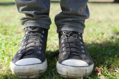 Gray sneakers on the grass Stock Photos