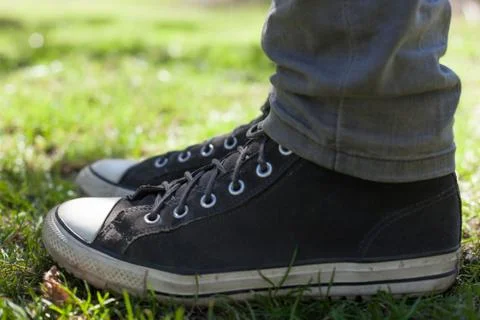 Gray sneakers on the grass Stock Photos
