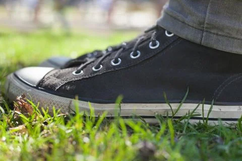 Gray sneakers on the grass Stock Photos