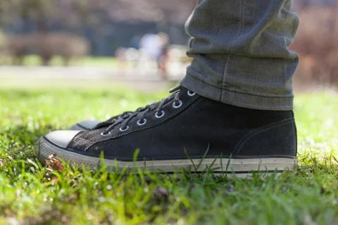 Gray sneakers on the grass Stock Photos