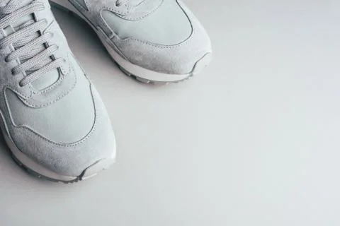 Gray sneakers on a gray background. Stock Photos