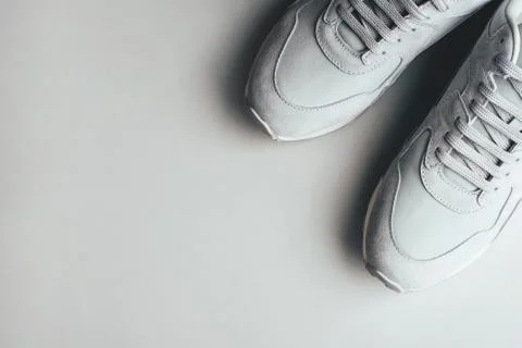 Gray sneakers on a gray background. Stock Photos