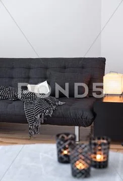 Gray sofa and cozy lights in the living room Stock Photos
