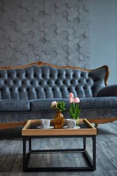 Gray sofa on a background of gray wall in classic livingroom Stock Photos