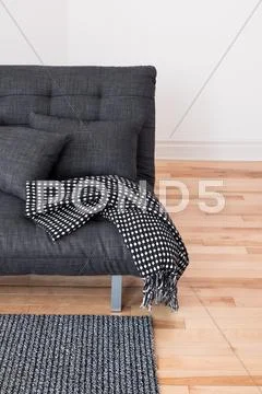 Gray sofa with cushions and throw Stock Photos