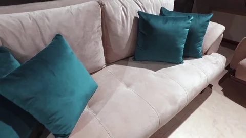 Gray sofa with turquoise pillows Stock Footage 79239789
