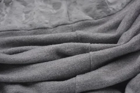 A gray soft fabric with delicate gray lace, a mesh with flower patterns. Stock Photos