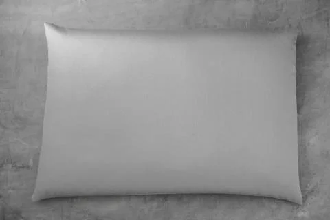Gray solid color pillow on a gray background. free space for advertising, logo Foto stock