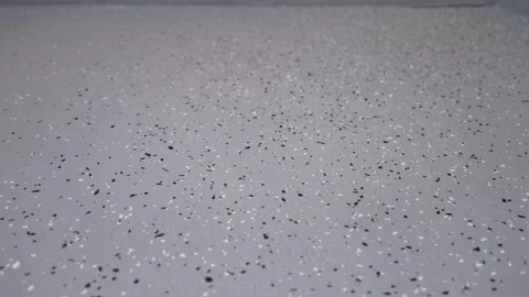 Gray speckled surface with black and white flecks Stock Footage 338384809