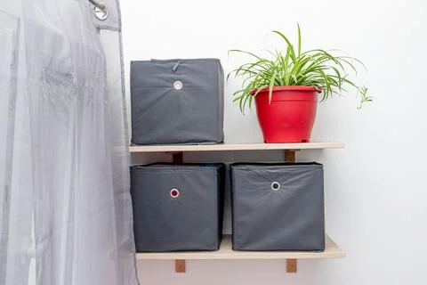 Gray square boxes for organizing space and storing things on shelf bedroom Stock Photos