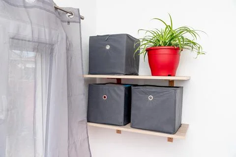 Gray square boxes for organizing space and storing things on shelf bedroom Stock Photos