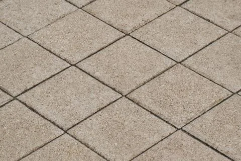 Gray square road tile close up. Perspective view. Minimalistic background Stock Photos