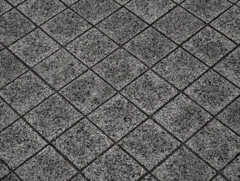 Gray square road tile close up. Perspective view. Minimalistic background Stock Photos
