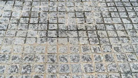 Gray Square Stone Sett Paving with a Grid Pattern Texture Stockfoto's