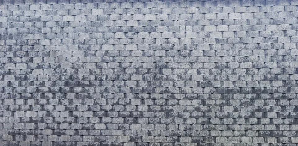 Gray Stacked Stone Wall with Repeating Brick Pattern Stock Photos