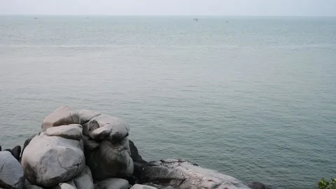 Gray stone and seascape with slow motion water wave, beautiful natural Stock Footage 239907921