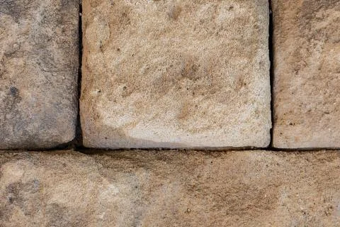 Gray stone background large blocks. Old cobblestone wall weathered Stock Photos