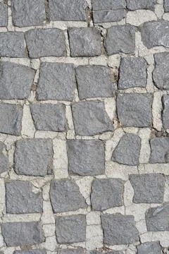 Gray stone cobblestone pavement texture background Stock Photos