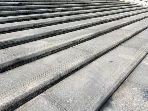 Gray stone steps leading upwards. Stock-Fotos