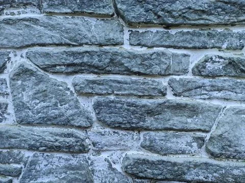 Gray stone texture. Part of a granite wall as texture or backdrop. Stock Photos