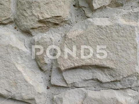 Gray stone wall background, mosaic stonewall rubble facade closeup texture Stock Photos