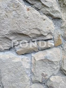 Gray stone wall background, mosaic stonewall rubble facade closeup texture Stock Photos