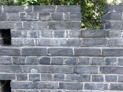 Gray stone wall with steps and a niche. Stock Photos