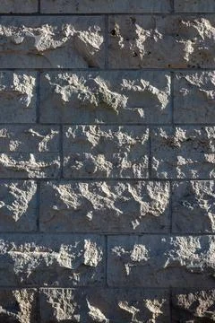 Gray stone wall texture background with rough masonry pattern Stock Photos