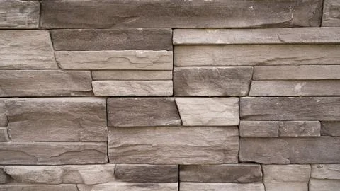 Gray stone wall texture with layered rectangular blocks and natural rough s.. Stock Photos