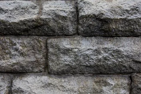 Gray stone wall. Textured background closeup. Stock Photos