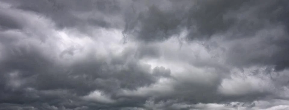 Gray storm clouds moving overhead in dramatic sky Stock Photos
