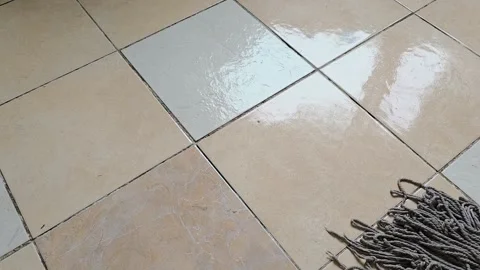 Gray string mop cleans across tiled flooring in a wiping motion, floor clea.. Stock Footage 344768087