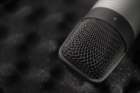 Gray studio condenser microphone on black soft foam Stock Photos