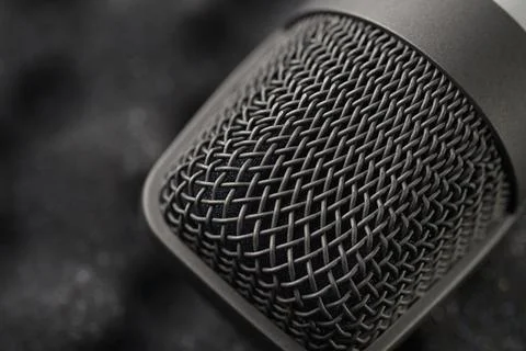 Gray studio condenser microphone on black soft foam Stock Photos