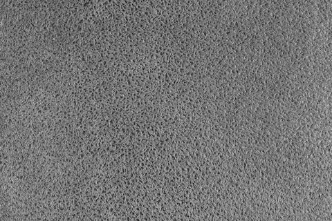 Gray suede leather texture with embossed spotted pattern background, fleecy.. Fotos de archivo