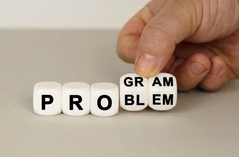 On a gray surface are white cubes with the inscription - PROGRAM or PROBLEM Stock Photos
