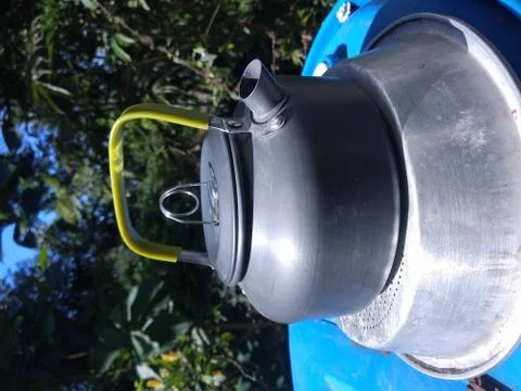 A gray teapot is on the table. Stock Photos