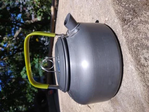 A gray teapot is on the table. Stock Photos