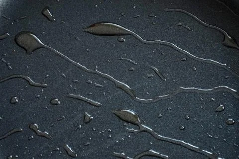 Gray Teflon with thin trickles of olive oil on the surface Stock Photos
