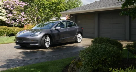 A gray Tesla Model 3 in the driveway of an upscale home, Seattle, Washington. Stock Footage 131512892