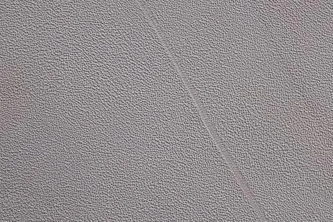 Gray textile background showing a stitched seam pattern 库存照片