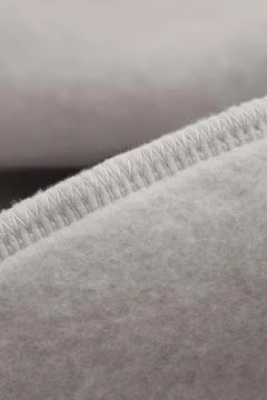 Gray textile with seam. Inner loop seam of clothing. Stock Photos