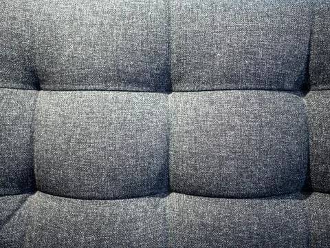 Gray textile texture of soft sofa with knobs Stock Photos