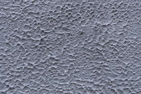 Gray texture of concrete wall of an old house. Decorative textured plaster Stock Photos