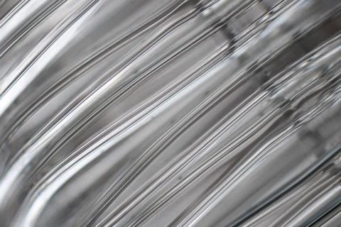 Gray texture with horizontal lines. Plastic, abstraction. Stock Photos