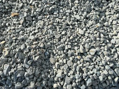 Gray texture of many large sharp hard gray stones, rubble, gravel. The backgr Stock Photos
