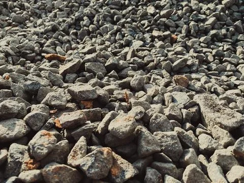 Gray texture of many large sharp hard gray stones, rubble, gravel. The backgr Stock Photos
