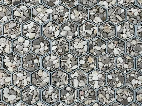 Gray texture with a metal grating in the form of honeycombs inside which ther Stock Photos